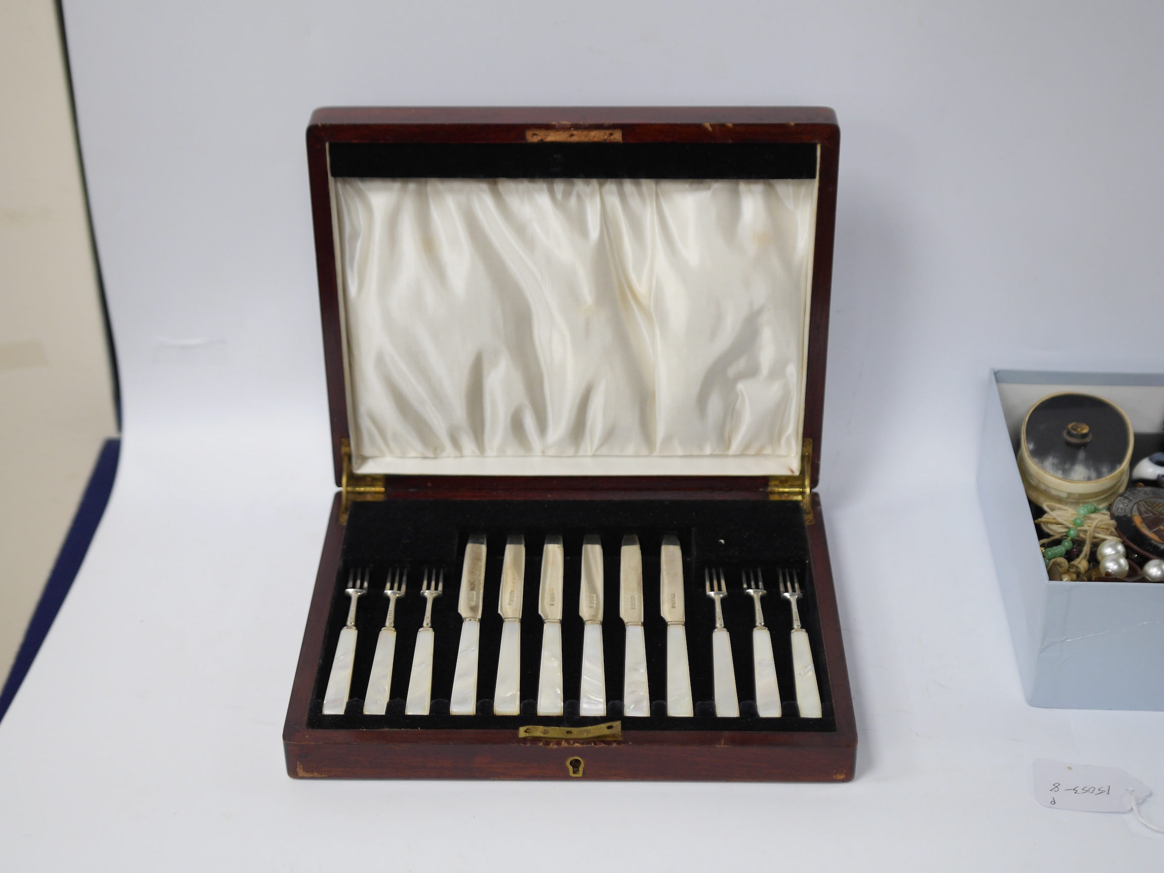 A cased set of six pairs of George V mother of pearl handled silver dessert eaters, by Thomas Bradbury & Sons, Sheffield, 1931, knife 17.5cm. Condition - fair to good